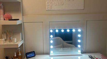 Luxelocksbyizz beauty station in Brentwood, England with a lighted mirror and elegant decor.