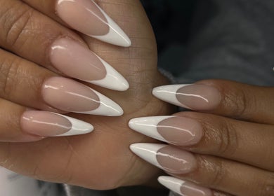 Elegant almond-shaped nails in a classic French manicure at Nailsbybodgyal, Ottawa, Ontario, CA.
