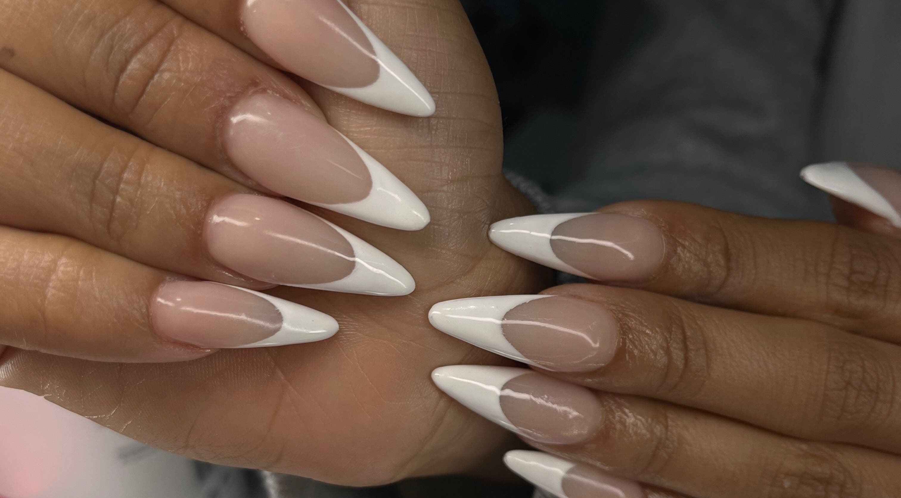 Stylish French manicure at Nailsbybodgyal in Ottawa, Ontario, CA, showcasing elegant pointed nail tips.