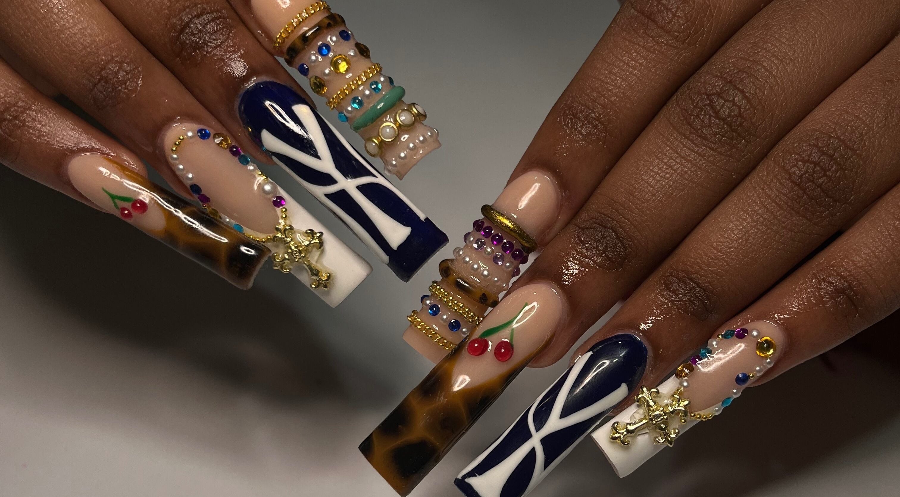 Intricate jeweled nail art at Nailsbybodgyal in Ottawa, Ontario, CA, showcasing a blend of gems and designs.