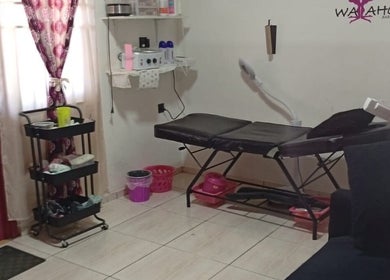 Cozy treatment room at WaXaholic, Paramaribo, Paramaribo, SR with a waxing table and beauty equipment.
