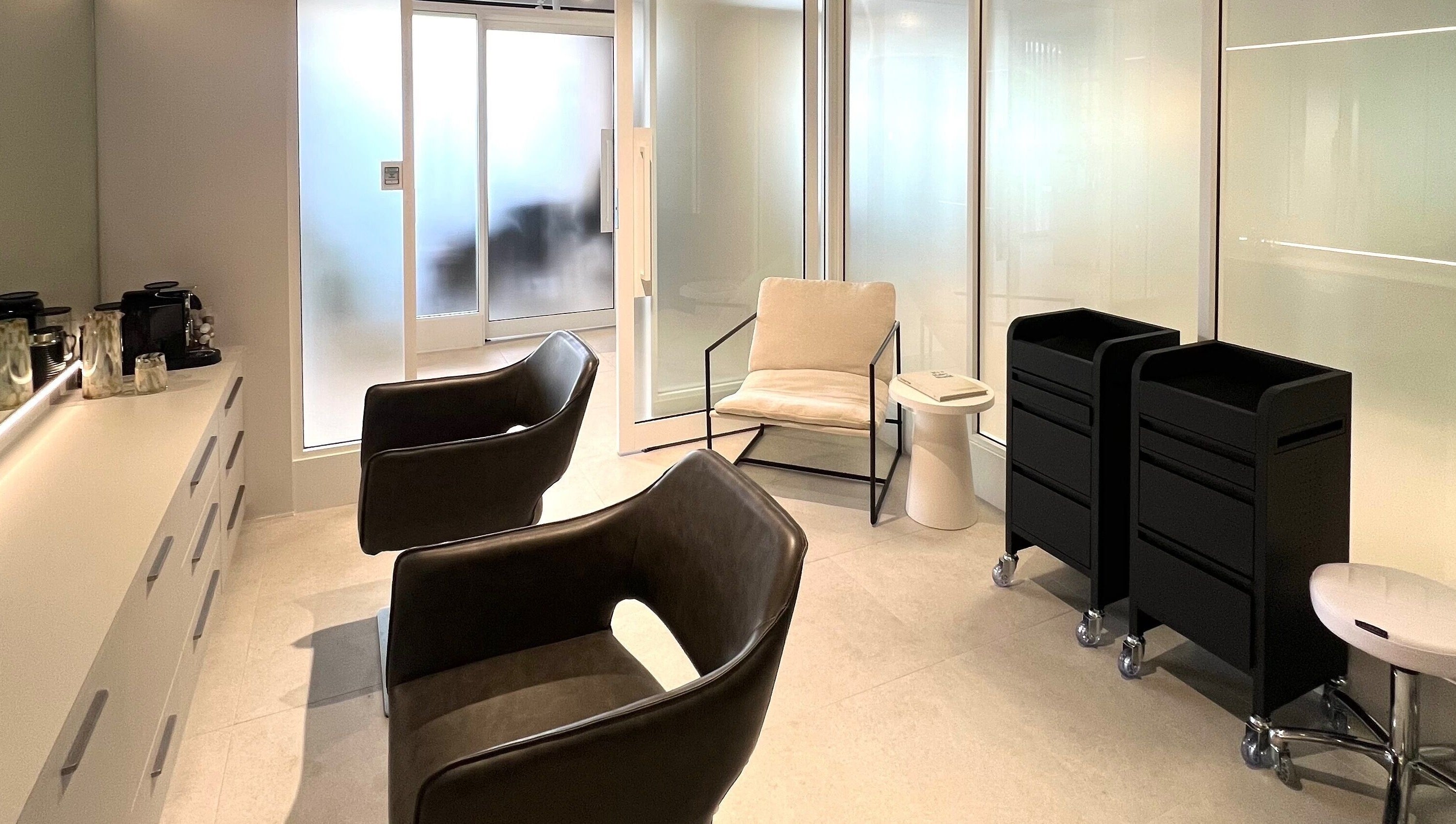 Modern salon interior of Kove Suite, Innaloo, Western Australia, AU, with sleek chairs and stylish decor.