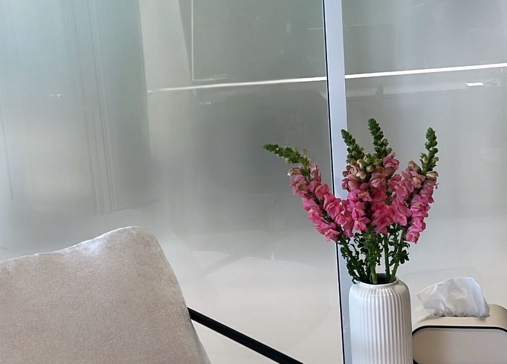 Elegant seating area with pink flowers at Kove Suite, Innaloo, Western Australia, AU.