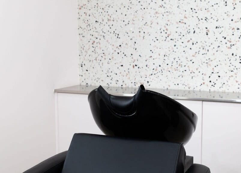 Modern wash station at LE PRETTY LITTLE SQUAD, Perth, Western Australia, AU, with sleek black seating.