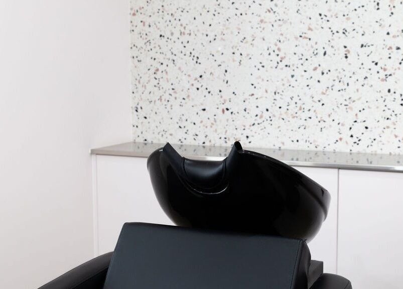 Modern wash station at LE PRETTY LITTLE SQUAD, Perth, Western Australia, AU, with sleek black seating.