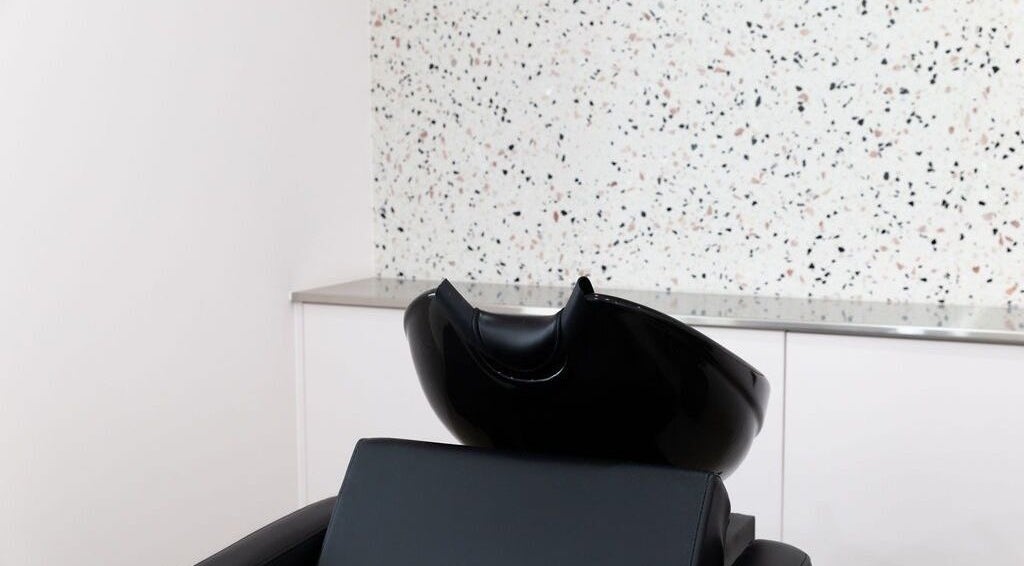 Modern wash station at LE PRETTY LITTLE SQUAD, Perth, Western Australia, AU, with sleek black seating.