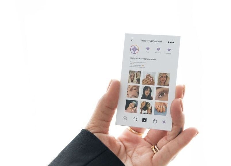 Hand holding the LE PRETTY LITTLE SQUAD profile card in Perth, Western Australia, AU.