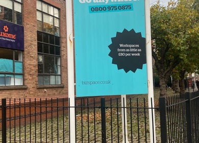 Brick building exterior near MassaAge, Manchester, England, GB with workspace signage.