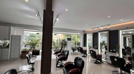 Modern interior of Behind The Chair by Reymark Castro Salon, Quezon City, Metro Manila, PH, with stylish stations.