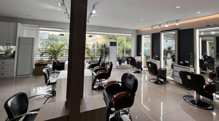 Spacious interior of Behind The Chair by Reymark Castro Salon in Quezon City, Metro Manila, PH, featuring modern chairs.