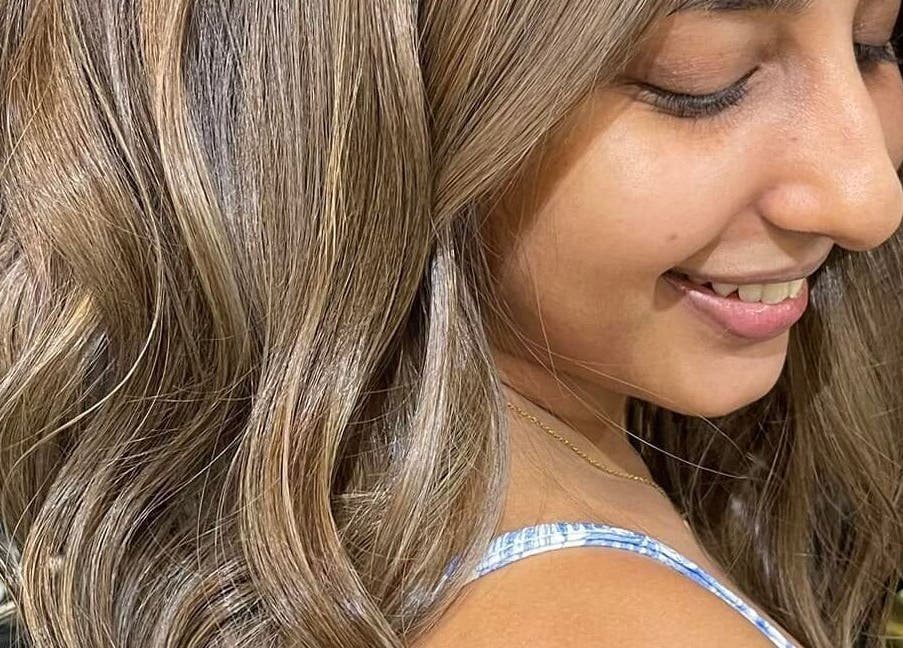Smiling woman with wavy brunette hair at Behind The Chair Salon | Quezon City Branch, Quezon City, Metro Manila, PH.