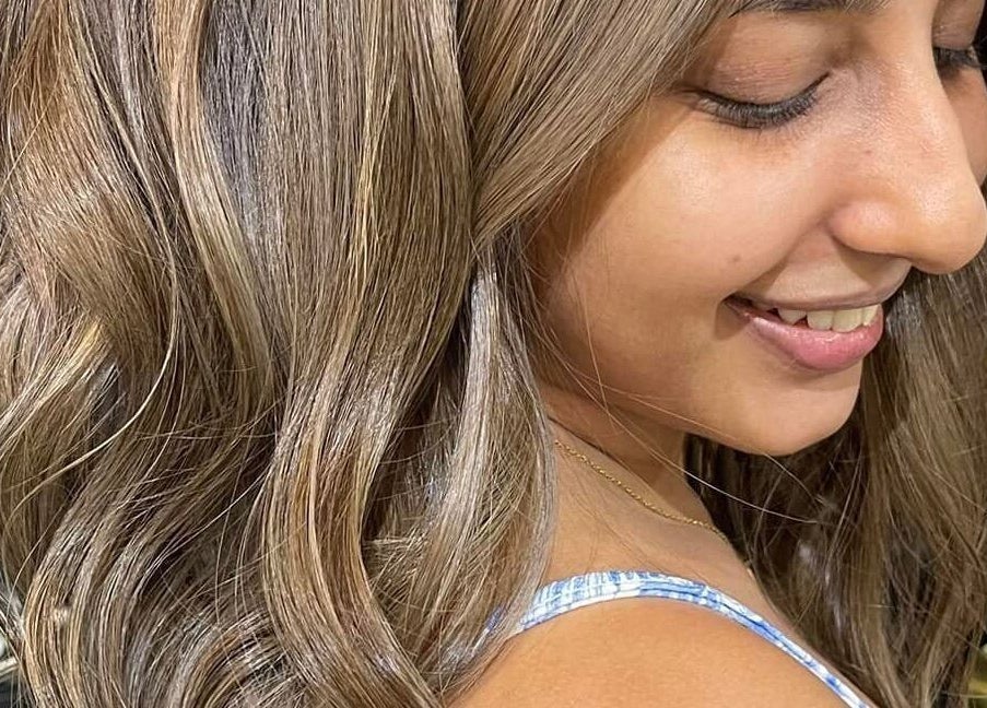 Smiling woman with wavy brunette hair at Behind The Chair Salon | Quezon City Branch, Quezon City, Metro Manila, PH.