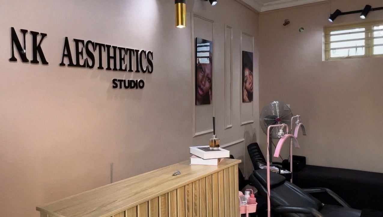 Inside NK Aesthetics, Ibadan, Oyo, NG showing a stylish reception and relaxing treatment chairs.