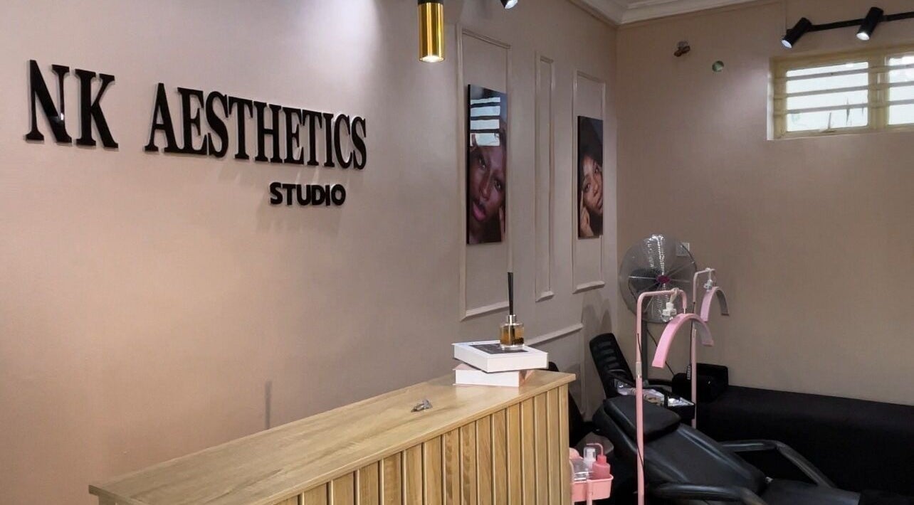 Inside NK Aesthetics, Ibadan, Oyo, NG showing a stylish reception and relaxing treatment chairs.