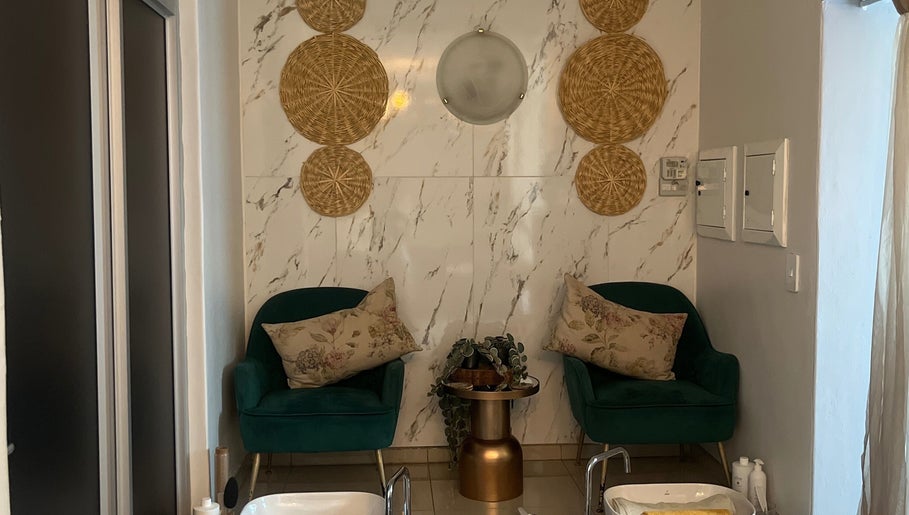 Elegant spa seating area at Meraki Wellness Centre, Windhoek, Khomas Region, NA with lush decor and plants.