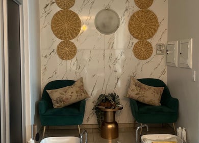 Elegant spa seating area at Meraki Wellness Centre, Windhoek, Khomas Region, NA with lush decor and plants.