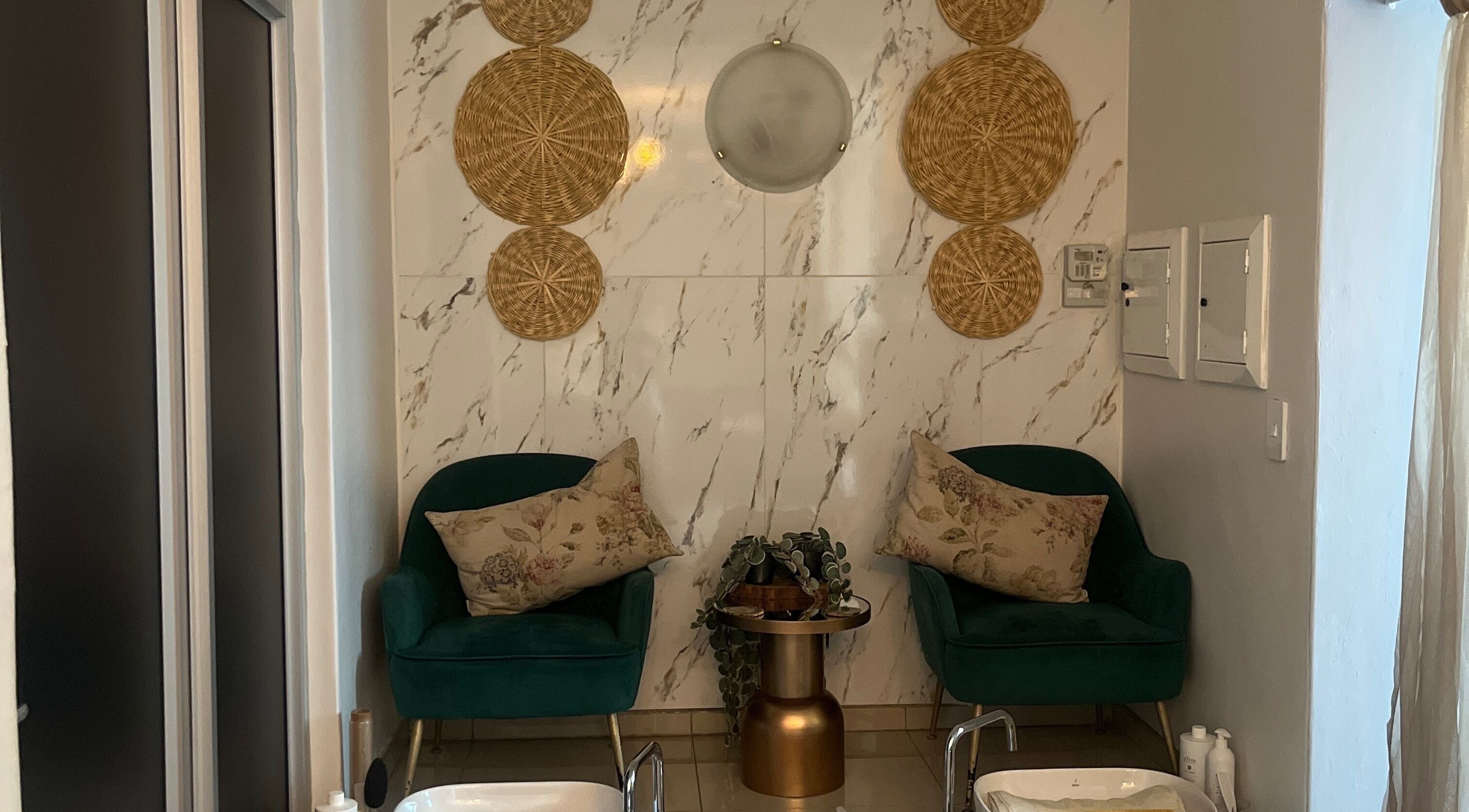 Elegant spa seating area at Meraki Wellness Centre, Windhoek, Khomas Region, NA with lush decor and plants.