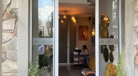 Entrance of Meraki Wellness Centre, Windhoek, Khomas Region, NA featuring elegant decor and warm lighting.