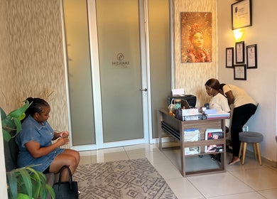 Reception area of Meraki Wellness Centre in Windhoek, Khomas Region, NA with staff and visitor.