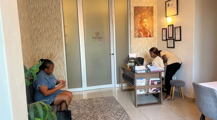 Reception area of Meraki Wellness Centre in Windhoek, Khomas Region, NA with staff and visitor.