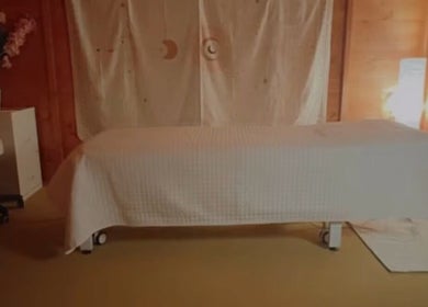 Tranquil therapy room at Xtremetherapeutics, Bootle, England, GB with a massage table and soft lighting.