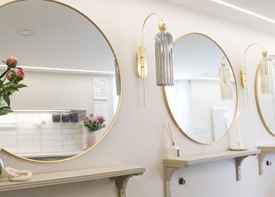 Elegant round mirrors and chic decor at Gemma Mason Hair, Stockport, England, GB.