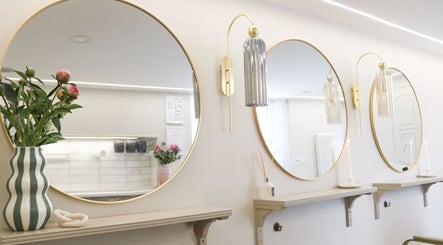 Elegant round mirrors and chic decor at Gemma Mason Hair, Stockport, England, GB.