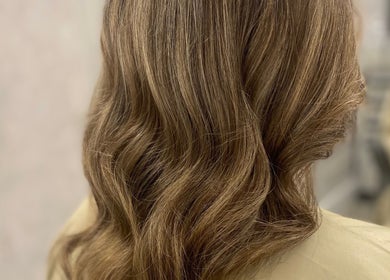 Elegant wavy hairstyle by Gemma Mason Hair in Stockport, England, GB showcasing luxurious brown tones.