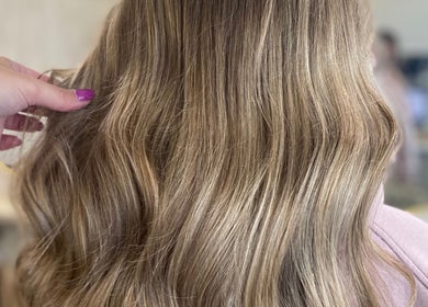 Glossy blonde waves styled at Gemma Mason Hair, Stockport, England, GB.