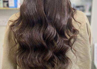 Elegant wavy brown hairstyle at Gemma Mason Hair, Stockport, England, GB.