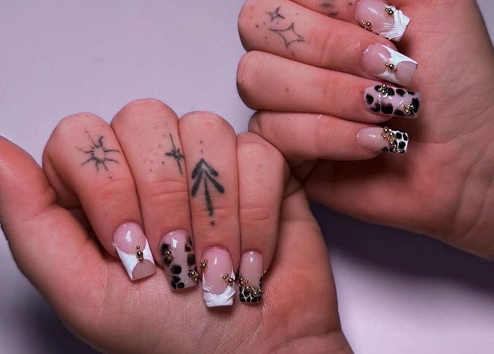 Elegant nail art with gemstones at ClawsByCasey, Gateshead, England, GB showcasing intricate patterns.