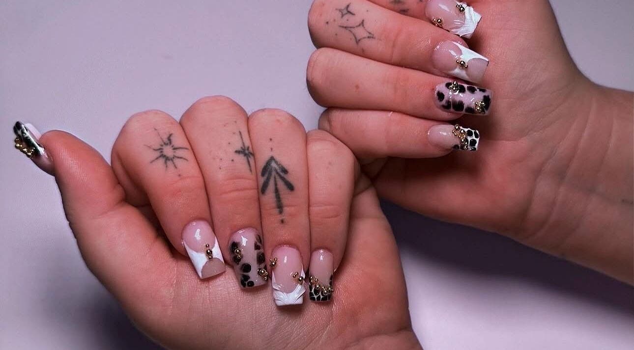 Elegant nail art with gemstones at ClawsByCasey, Gateshead, England, GB showcasing intricate patterns.