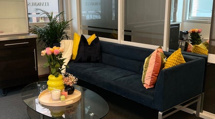 Inviting seating area at Maniq in Nesbru, Akershus, NO with a sleek sofa and vibrant decor.