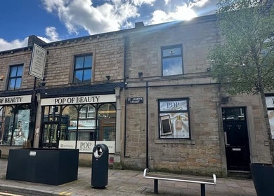 Gracella.beauty venue in Burnley, England, GB showcasing a welcoming stone facade under a clear sky.