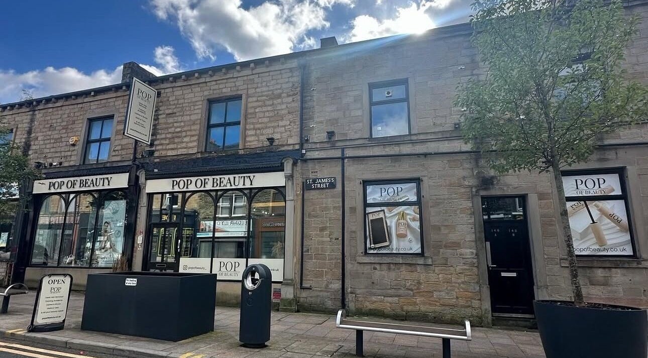 Gracella.Beauty venue in Burnley, England, GB, showcasing a stylish stone building exterior on a sunny day.