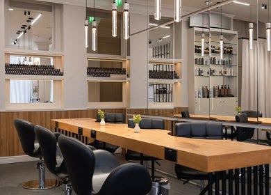 Modern salon interior at Sakurami London, featuring stylish seating and mirrors. Located in London, England, GB.