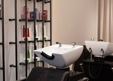 Sleek hair wash stations at Sakurami London salon in London, England, GB with premium hair products displayed.