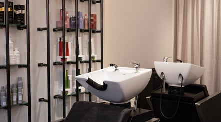 Sleek hair wash stations at Sakurami London salon in London, England, GB with premium hair products displayed.