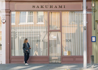 The stylish exterior of Sakurami London in London, England, GB with elegant signage and a passing pedestrian.