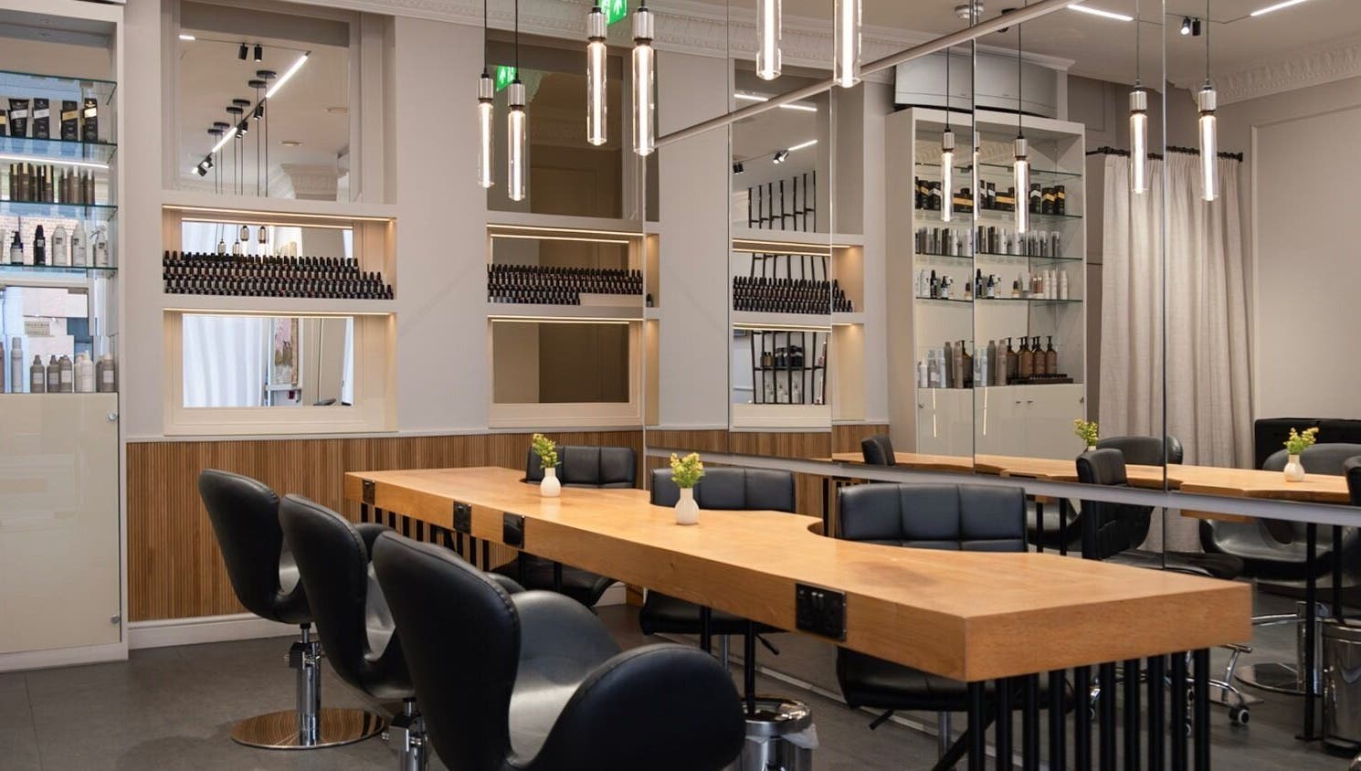 Modern salon interior at Sakurami London, featuring sleek chairs and wooden tables in London, England, GB.