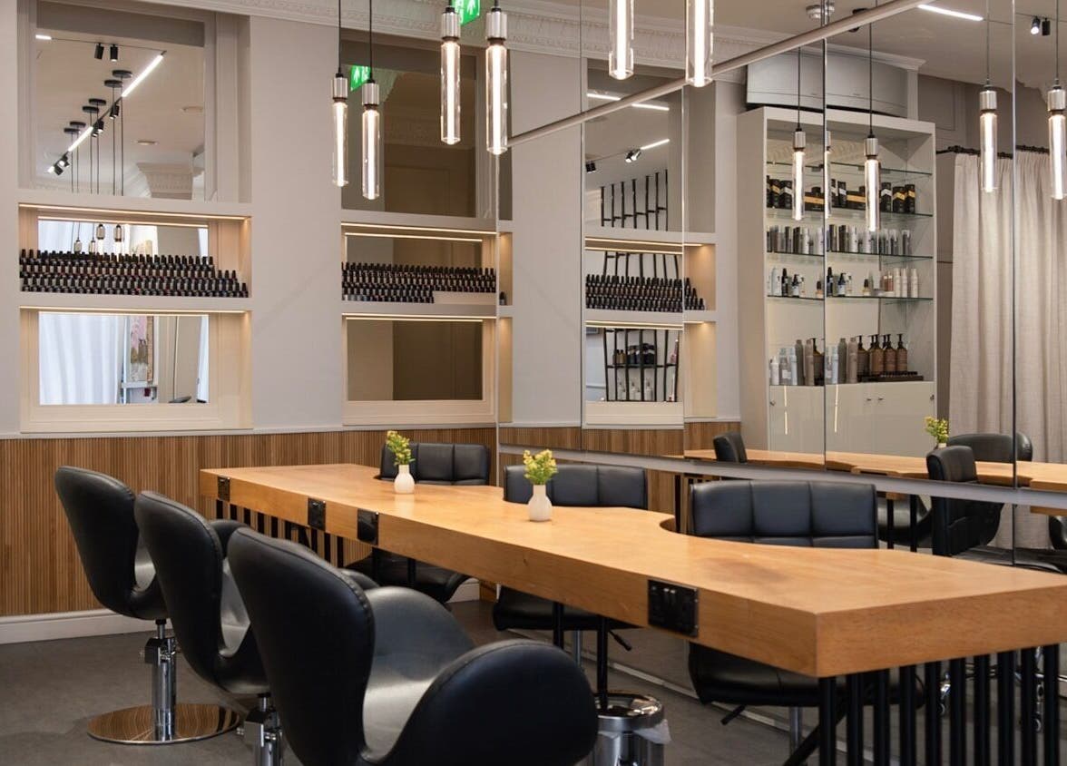 Modern salon interior at Sakurami London, featuring sleek chairs and wooden tables in London, England, GB.