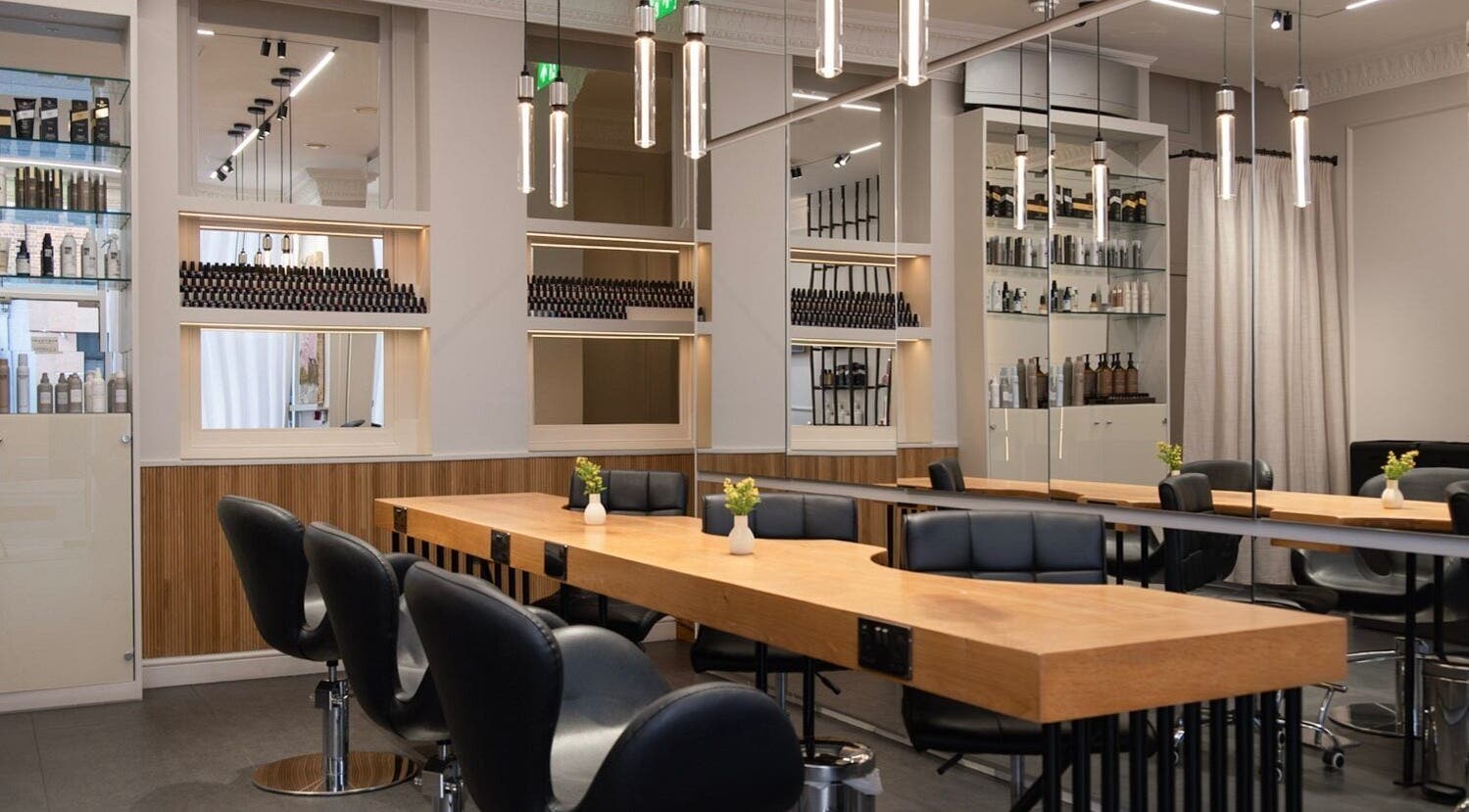 Modern salon interior at Sakurami London, featuring sleek chairs and wooden tables in London, England, GB.