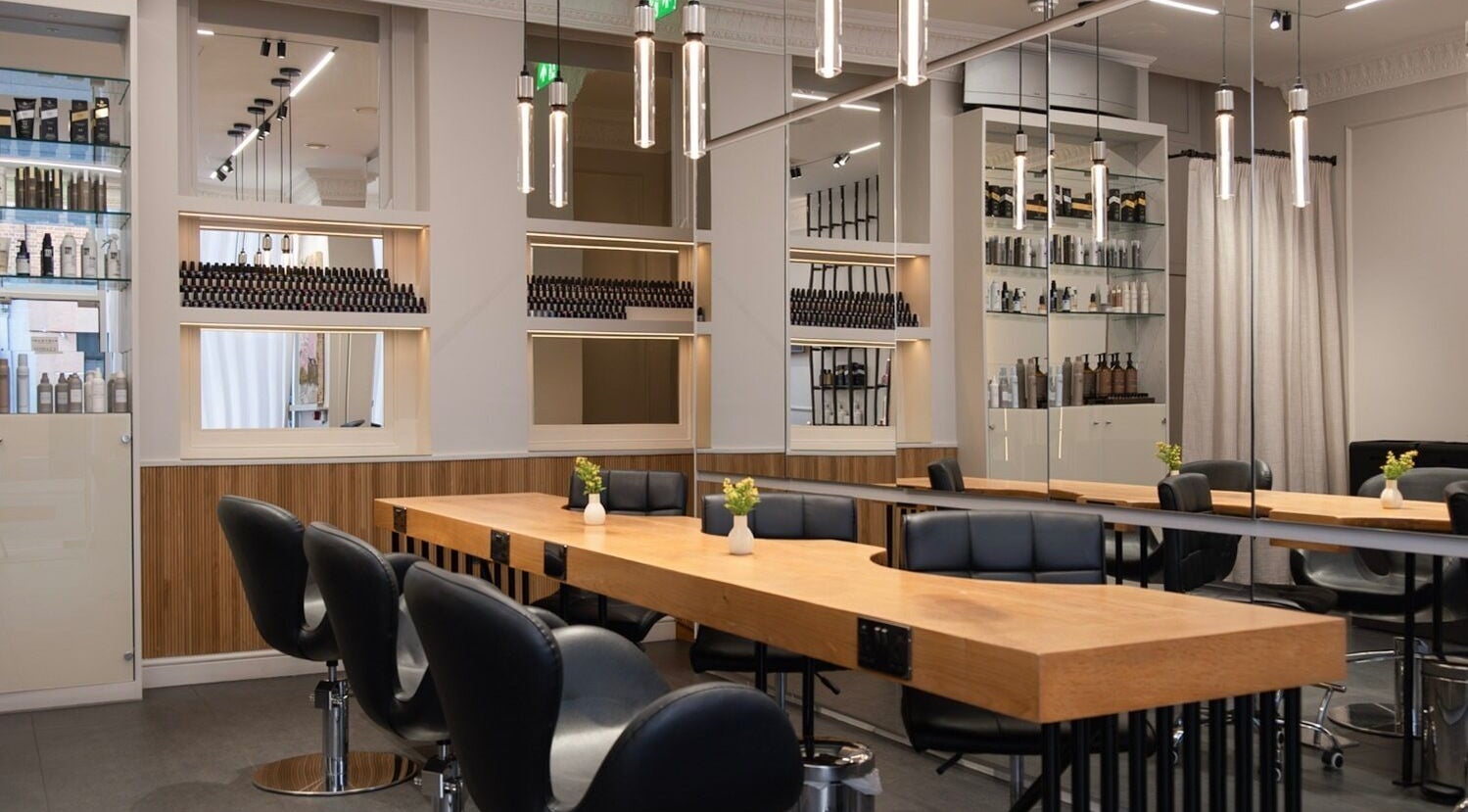 Modern salon interior at Sakurami London, featuring sleek chairs and wooden tables in London, England, GB.