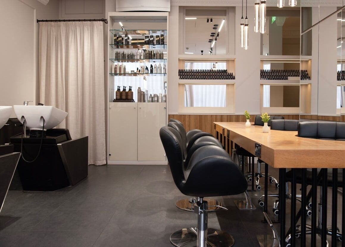 Modern salon interior at Sakurami London, London, England, GB, featuring sleek styling chairs and mirrors.