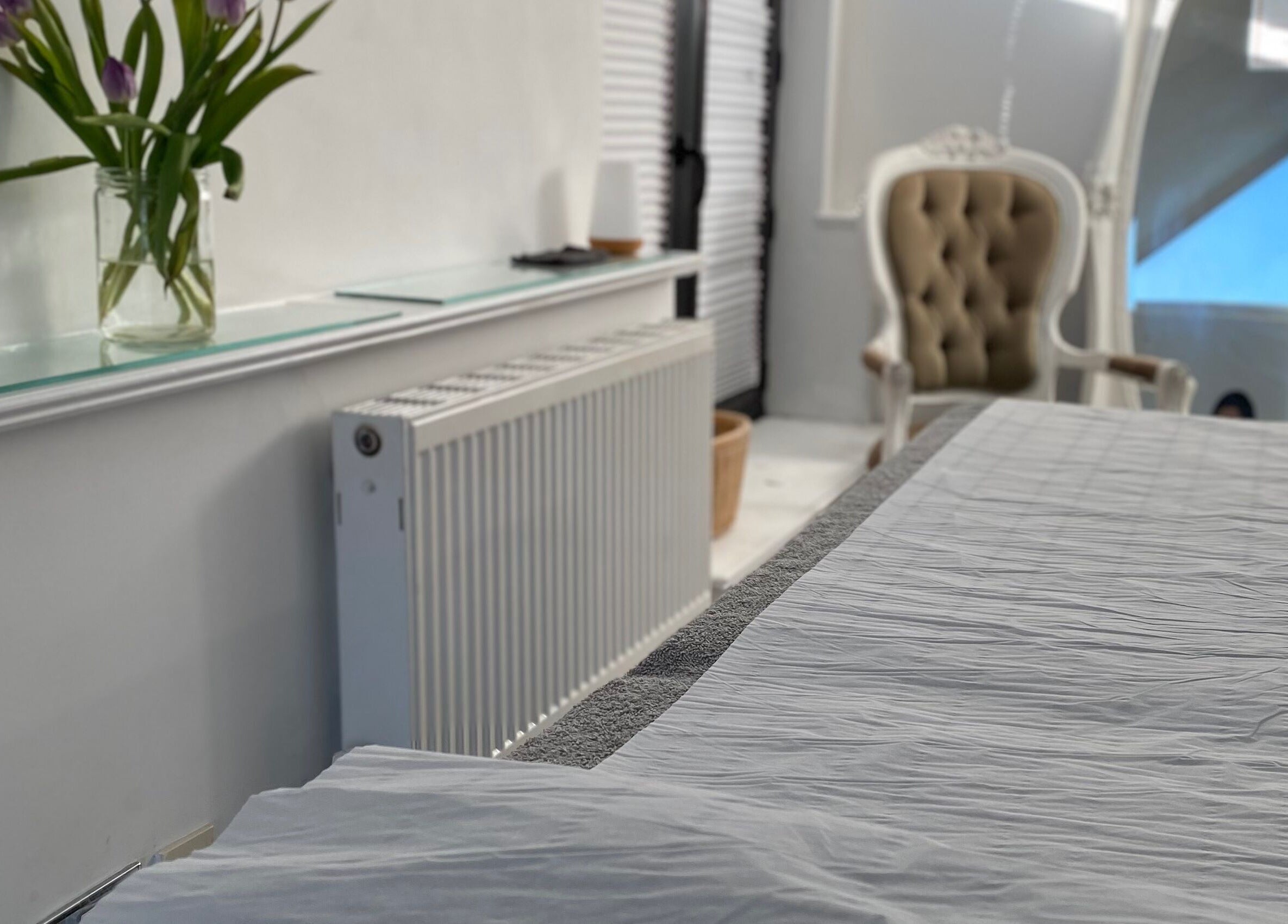 Elegant treatment room at Raha Aesthetics, Cardiff, Wales, GB, featuring a plush chair and calming ambiance.