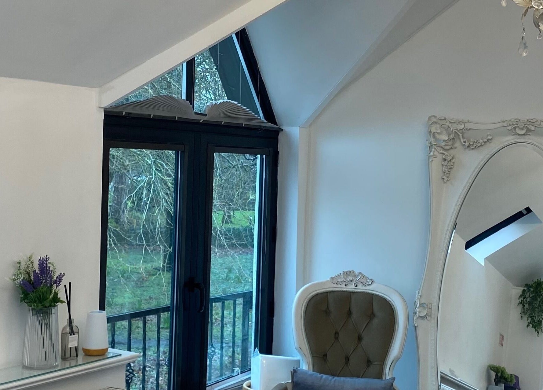Elegant chair and mirror in a tranquil room at Raha Aesthetics, Cardiff, Wales, GB.