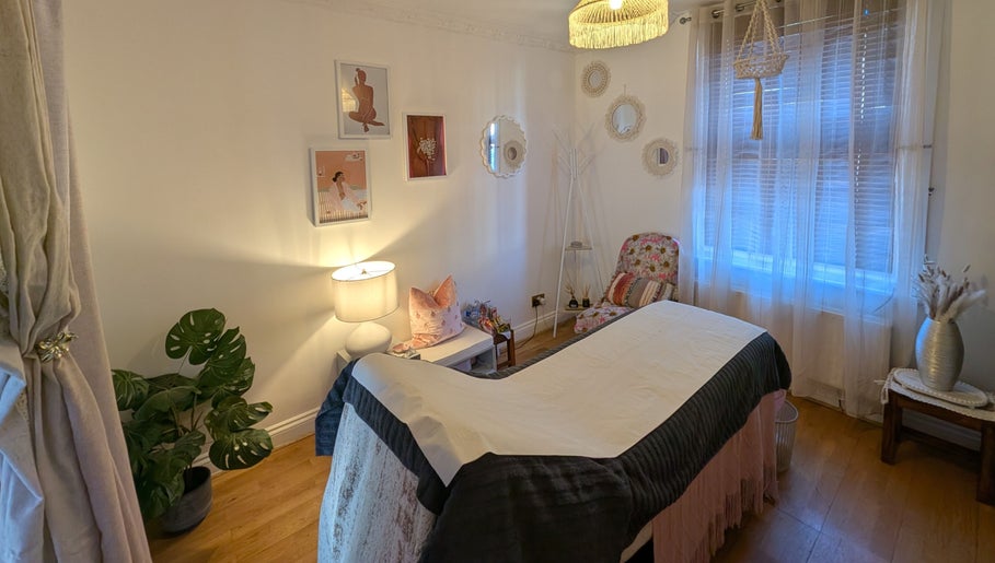 Cozy treatment room at Peach Beauty, London, England, GB with soft lighting and elegant decor.