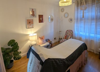 Cozy treatment room at Peach Beauty, London, England, GB with soft lighting and elegant decor.