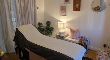 Luxury treatment room at Peach Beauty in London, England, GB, featuring a massage bed with elegant decor.
