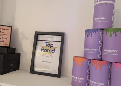 Peach Beauty in London, England, GB showcases beauty products and a top-rated 2024 certificate on a shelf.